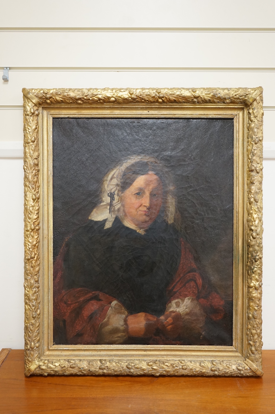 A mid 19th century, English School, oil on canvas, Portrait of an elderly lady wearing a bonnet, with details of the sitter verso, 62 x 49cm, gilt framed